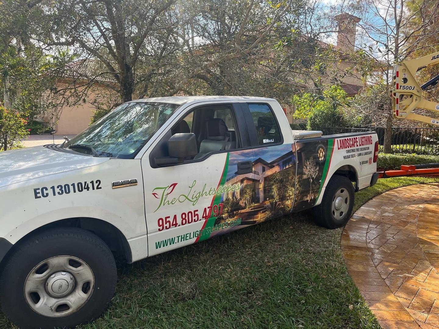 Lightscapes landscape lighting service truck at a residential outdoor landscaping project